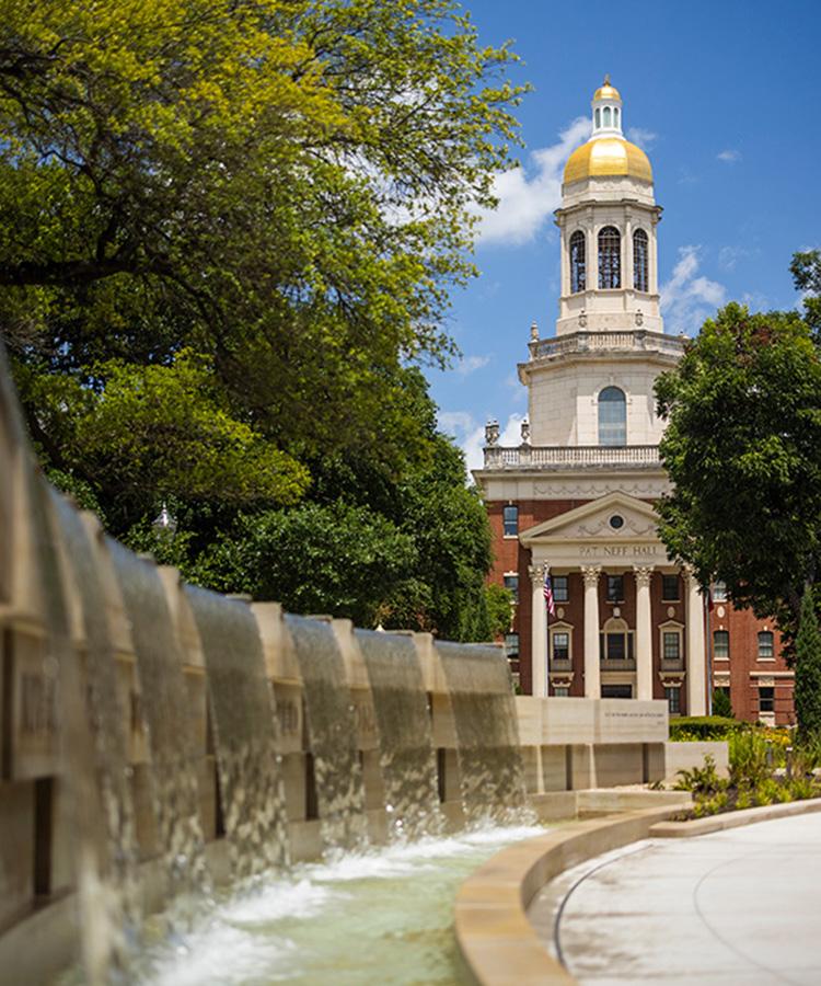 Pat Neff Hall on Baylor's campus with the fountain from the Monument to Enslaved Persons in the foreground